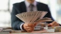 Businessman banker holding fan of dollar bills in hand closeup