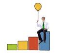 Businessman on a Bar Graph Holding a Balloon Royalty Free Stock Photo