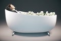 Businessman in bathtub with cash