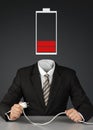 Businessman with battery head and plug, charge you mind concept Royalty Free Stock Photo