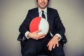 Businessman with beach ball in office chair Royalty Free Stock Photo