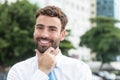 Businessman with beard and blue tie in the city