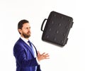Businessman with beard tosses or cathes briefcase. Business offer concept.