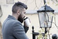 Businessman bearded guy drink coffee outdoors. Hipster hold paper coffee cup and enjoy park environment. Relaxing coffee Royalty Free Stock Photo