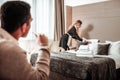 Businessman behaving immoral watching hotel maid working Royalty Free Stock Photo