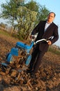 The businessman behind a tractor. Royalty Free Stock Photo