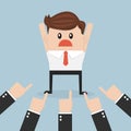 Businessman being pointed at by a lot of hands. Royalty Free Stock Photo