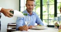 Businessman is being waited on a glass during lunch meeting