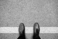 Black shoes standing on white line