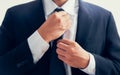 Businessman in black suit and adjusting necktie Royalty Free Stock Photo