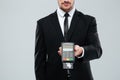 Businessman in black suit holding bank terminal with credit card