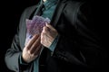 Businessman in black suit holding 500 euro bills