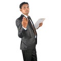 Businessman in black suit with pen and clipboard presenting Royalty Free Stock Photo