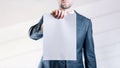 Businessman blank card. White blank board template holding business man on white background. Copy space empty poster. Royalty Free Stock Photo