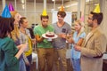 Businessman blowing candles on her birthday cake