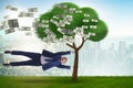 Businessman blown away from the money tree Royalty Free Stock Photo