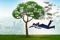 Businessman blown away from the money tree Royalty Free Stock Photo