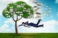 Businessman blown away from the money tree Royalty Free Stock Photo