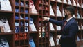 Businessman in blue jacket choosing tie in shop boutique Royalty Free Stock Photo