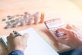 Businessman in blue shirt Hand holding pen writing,Calculation with calculator and Financial data analyzing and counting Royalty Free Stock Photo