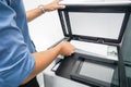 Businessman in blue shirt lift the printer plate up for document scanning