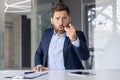 Businessman in blue suit angrily pointing during a video call Royalty Free Stock Photo