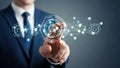 Businessman in a blue suit touching a glowing blue digital network of interconnected nodes and lines Royalty Free Stock Photo