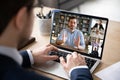 View over businessman shoulder laptop screen and videocall diverse participants Royalty Free Stock Photo