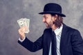 Businessman with bowler hat in black suit showing money Royalty Free Stock Photo