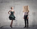 Businessman with a box on his head and a beautiful woman Royalty Free Stock Photo