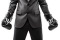 Businessman boxer in black suit wearing sport boxing gloves