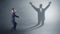 Businessman fighting with a disarmed businessman shadow Royalty Free Stock Photo