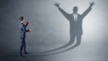 Businessman fighting with a disarmed businessman shadow Royalty Free Stock Photo