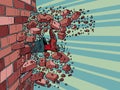 Businessman breaks through a brick wall. The will to overcome obstacles