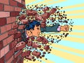 Businessman breaks through a brick wall. The will to overcome obstacles