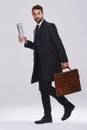 Businessman, briefcase and career walking in studio for employee commute, white background or mockup space. Male person