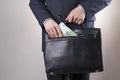 Businessman with a briefcase full of money in the hands of Royalty Free Stock Photo