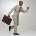 Businessman, briefcase and running in studio as lawyer or late meeting, time management or corporate. Male person, rush