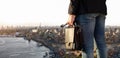 A businessman with a briefcase stands against the backdrop of the big city Royalty Free Stock Photo