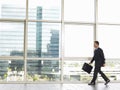 Businessman With Briefcase Walking In Office Royalty Free Stock Photo