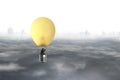 Businessman in brightly yellow lamp hot air balloon flying Royalty Free Stock Photo