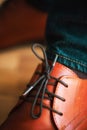 Businessman brown leather shoes with shoelaces on wooden parquet floor. Style and fashion concept.