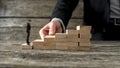 Businessman building a staircase for another entrepreneur to climb up