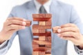 Businessman building tower of wooden blocks Royalty Free Stock Photo