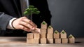 Businessman building a tower of wooden blocks with a green tree in the center, Enviroment concepts, Generative AI illustration Royalty Free Stock Photo