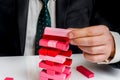 Businessman builds big tower with jenga bricks Royalty Free Stock Photo