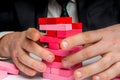 Businessman builds big tower with jenga bricks Royalty Free Stock Photo