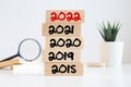 Businessman builds wooden blocks 2018, 2019, 2020, 2021, 2022. The concept of the beginning of the new year. New goals Royalty Free Stock Photo