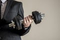 A businessman in business suit doing dumbbell biceps curl Royalty Free Stock Photo