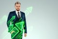 A businessman in a business suit looking for an opportunity against the background of green arrows pointing up. Development